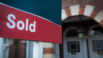 Estate agent sold sign for property